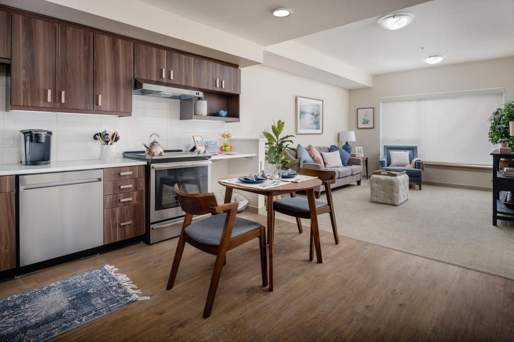 A modern and cozy open-plan apartment featuring a kitchen, dining area, and living room.