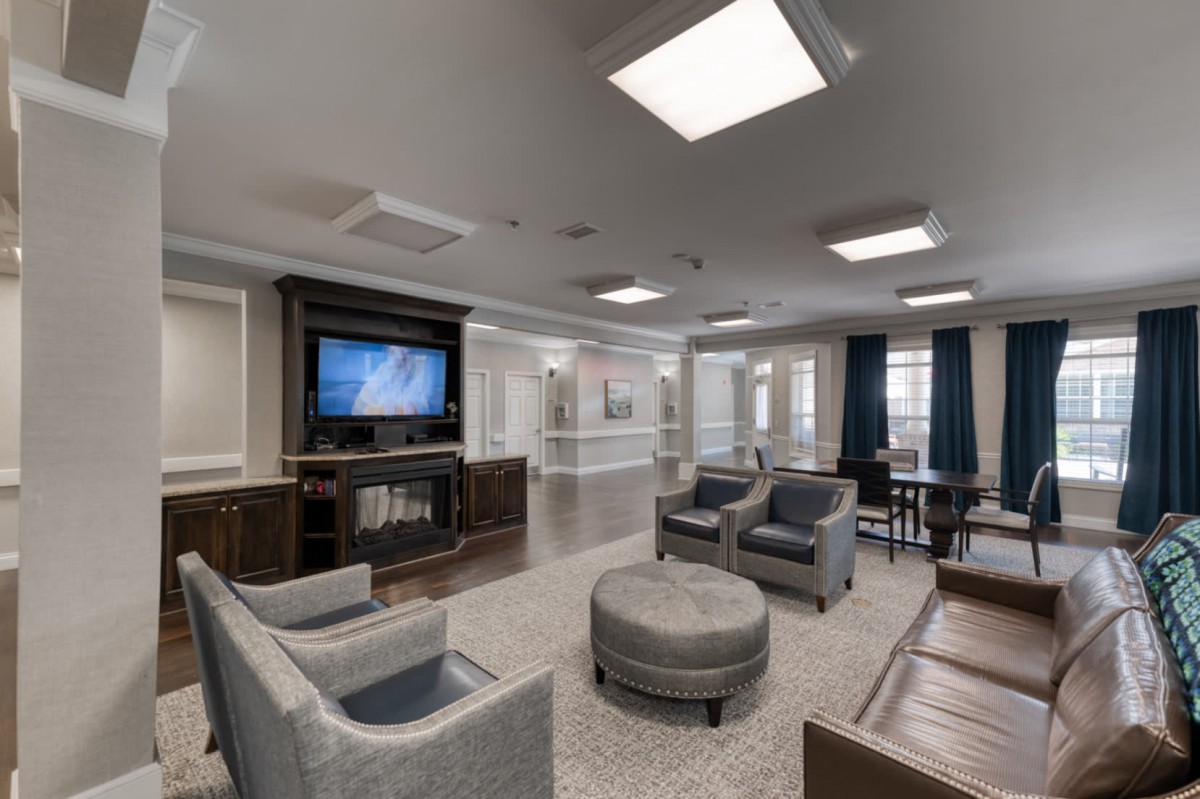 A modern living room with comfortable seating, a television, and stylish decor.