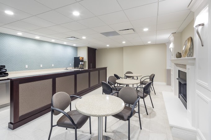 A modern cafe interior with tables, chairs, and a counter.