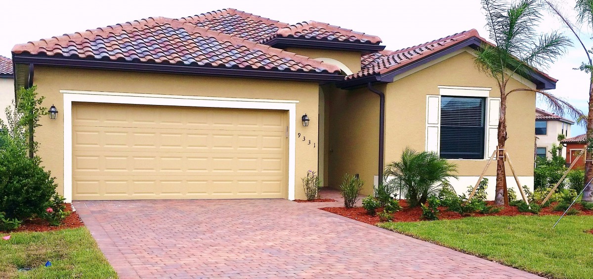 A suburban house with a tiled roof and a spacious driveway.