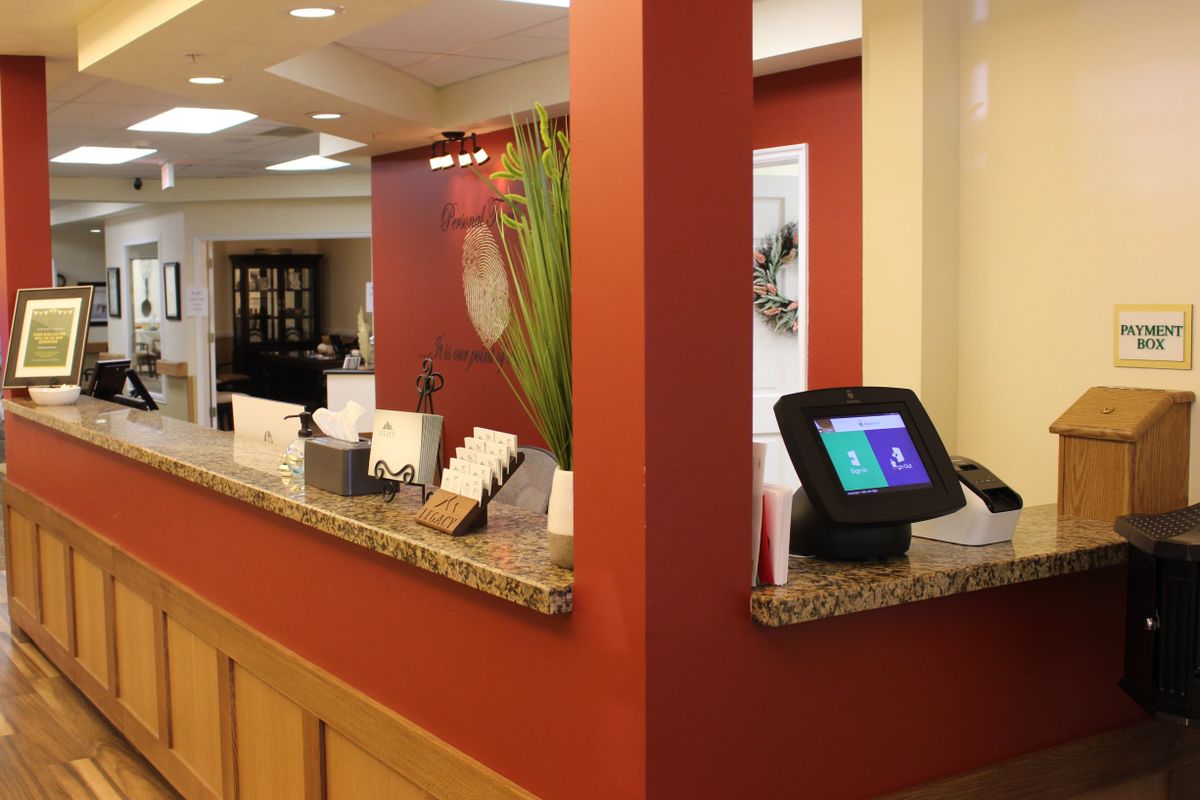 A welcoming hotel reception area with a modern check-in kiosk and decorative elements.