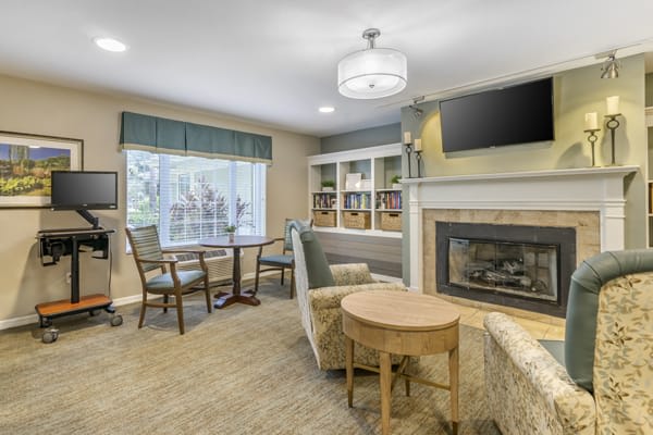 A cozy living room with a fireplace, comfortable seating, and a television.