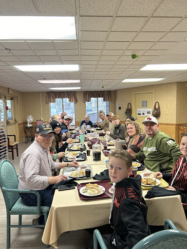 A lively gathering of friends and family enjoying a meal together.