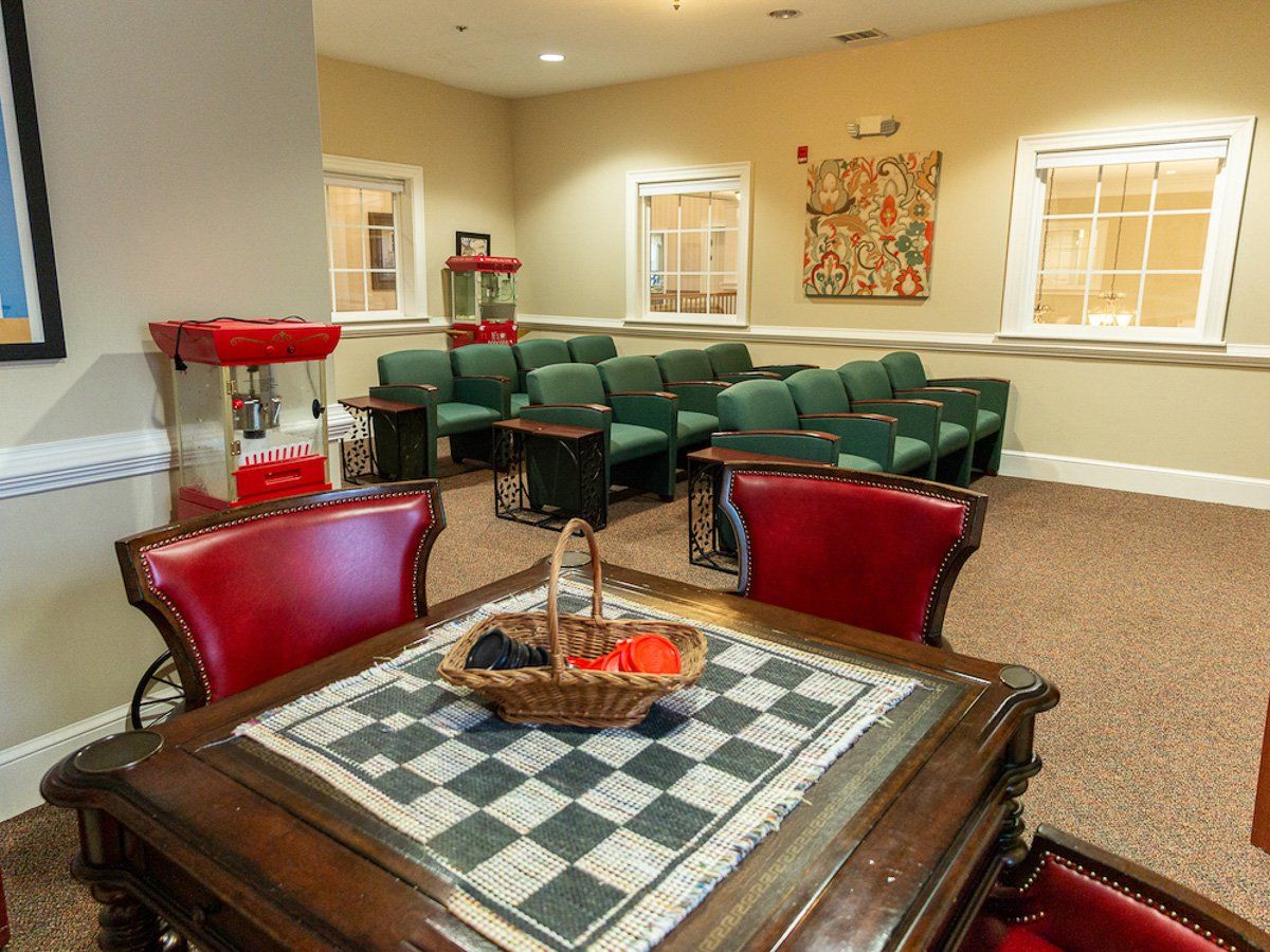 A cozy lounge with a chess table and popcorn machine, perfect for relaxation.