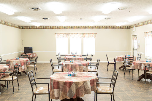 A spacious dining area with neatly arranged tables and chairs, designed for communal meals and gatherings.