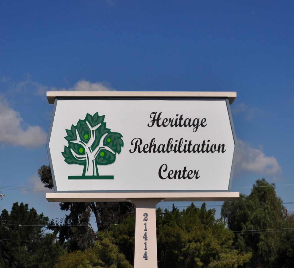 Sign for Heritage Rehabilitation Center with tree logo.