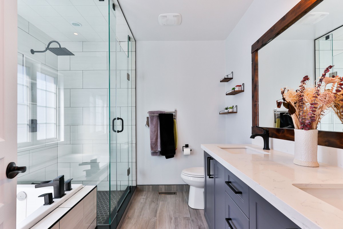 A modern bathroom with a glass shower enclosure and sleek design elements.