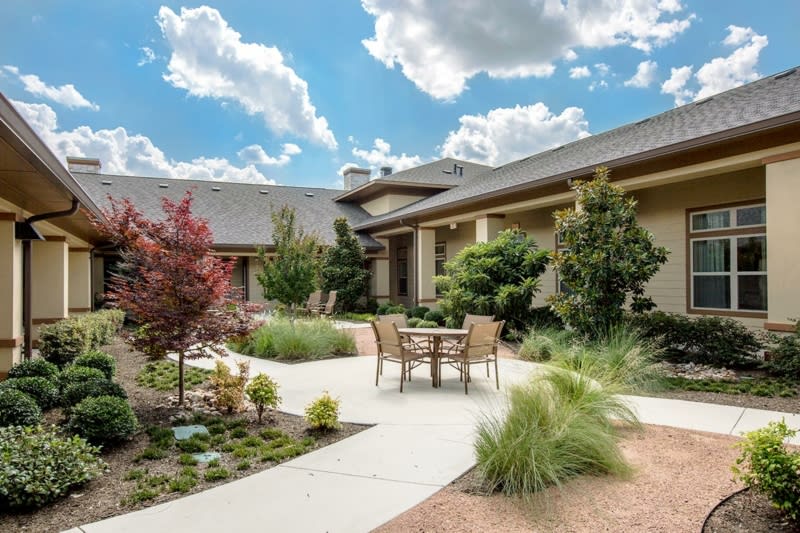 A beautiful home with a landscaped garden and cozy patio area.