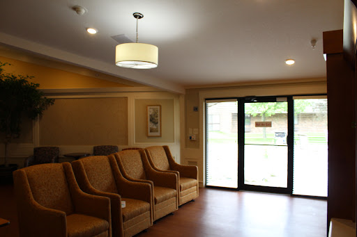 A cozy waiting area with comfortable seating and natural light entering through the glass door.