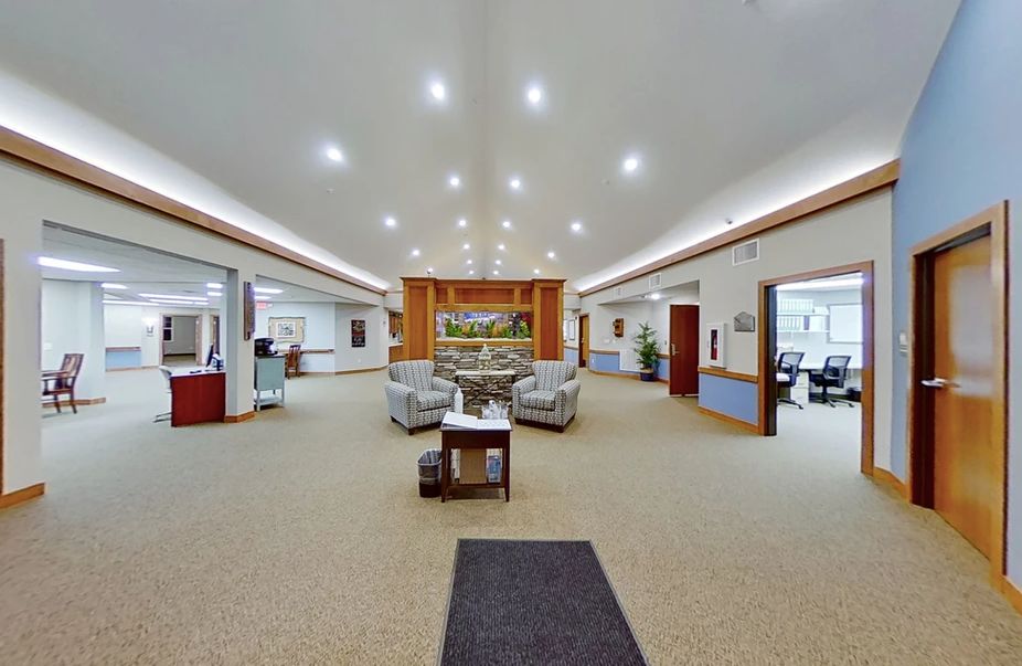 A spacious lobby with modern lighting and comfortable seating arrangements.