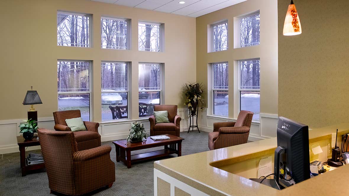 A cozy lobby area with comfortable seating and large windows.