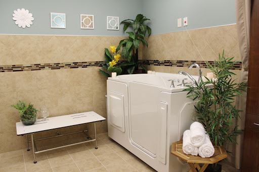 A serene spa bathroom featuring a whirlpool, towels, and plants for a relaxing atmosphere.