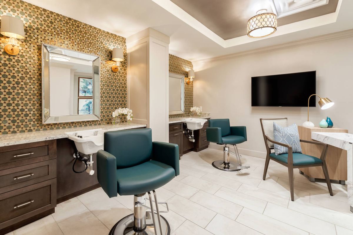 A modern salon interior with stylish chairs and elegant lighting.