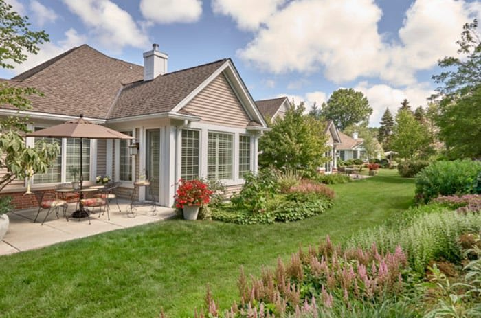 A beautiful residential house with a well-maintained garden and patio.