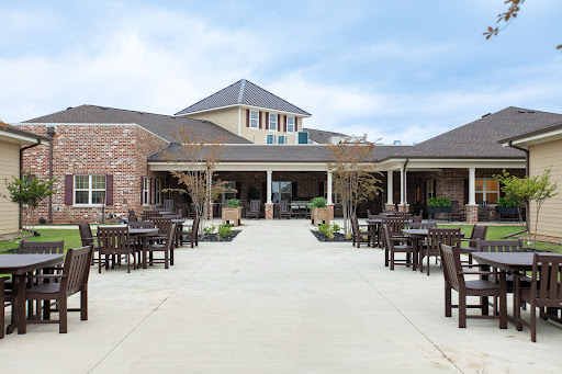 A welcoming outdoor patio area surrounded by a beautifully designed residential building.