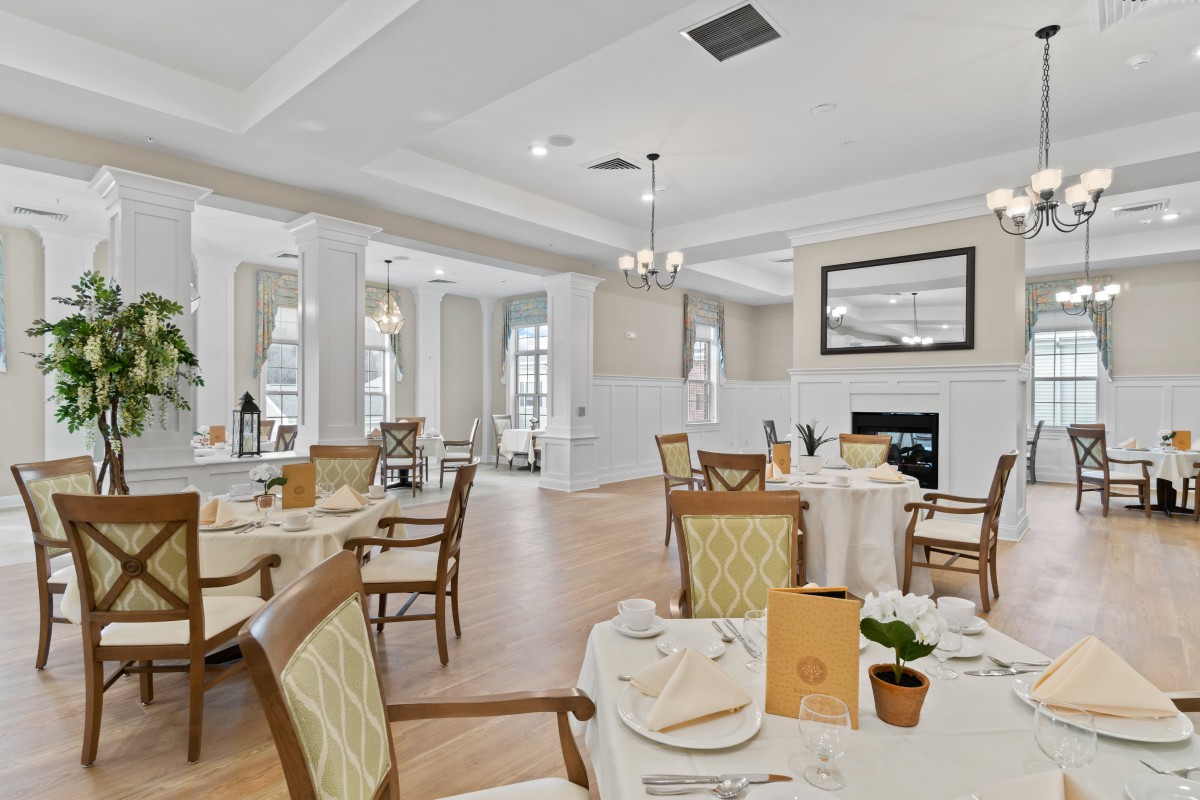 An elegant dining room with neatly arranged tables and chairs.