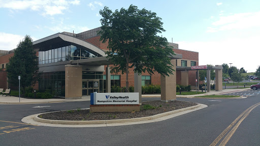 Exterior view of a modern medical facility with clear signage.