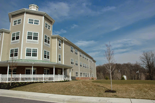 A modern residential building set against a clear blue sky.