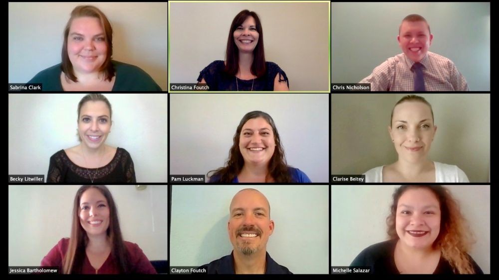 A group of people participating in a virtual video conference, each appearing in individual windows.
