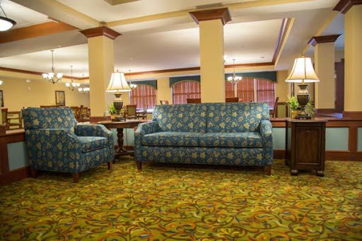 A cozy hotel lobby featuring patterned furniture and warm lighting.