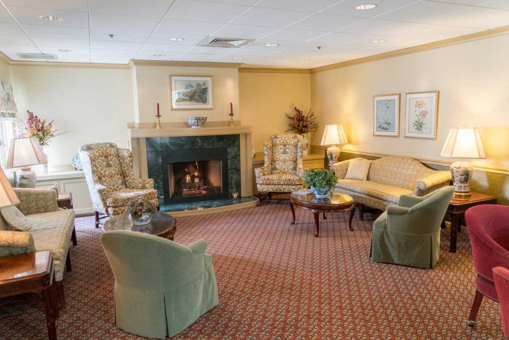 A cozy living room with a fireplace and comfortable seating.