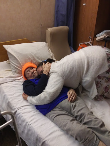 A heartfelt moment of support and affection in a hospital setting.