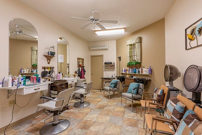 A cozy salon interior with multiple chairs and mirrors set up for hair styling.