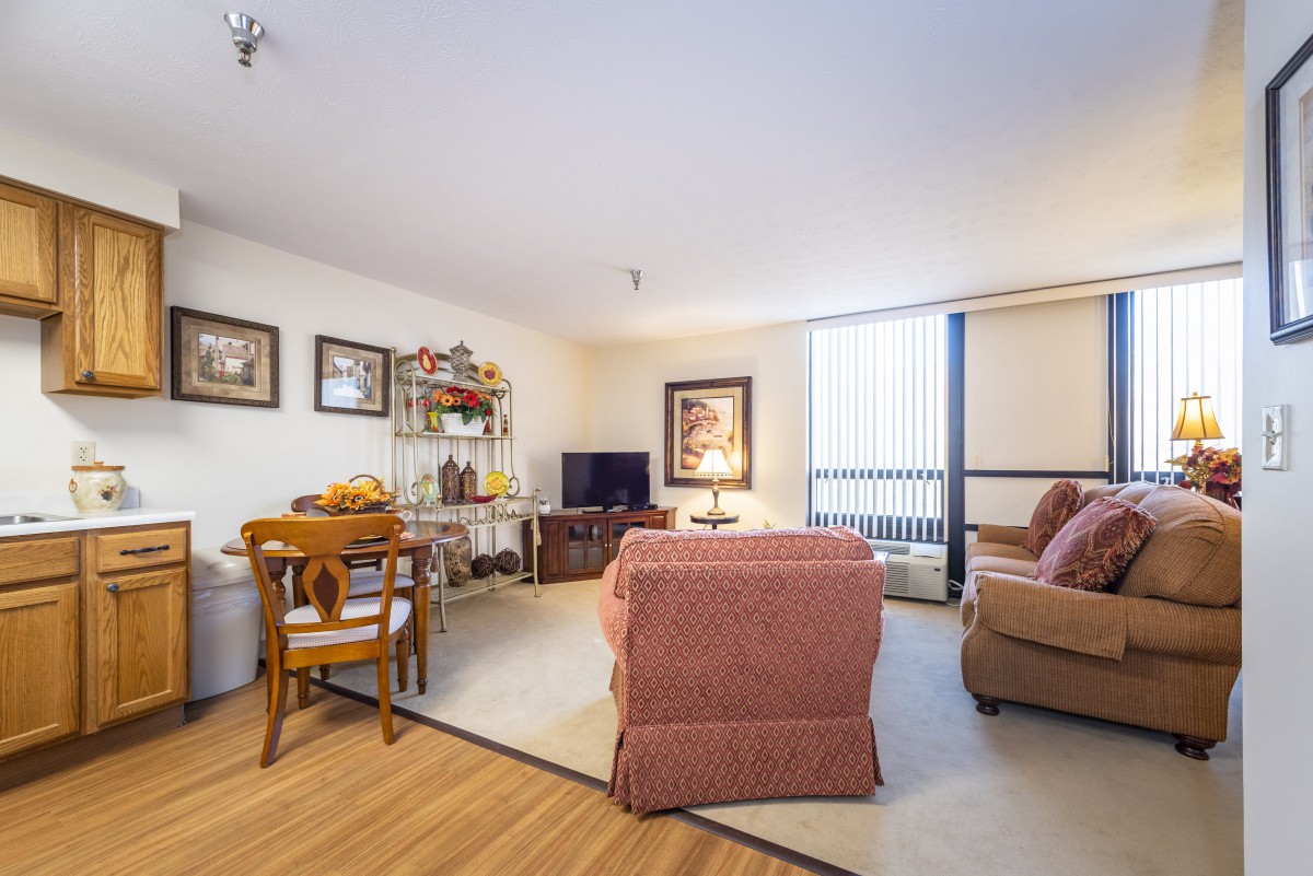 A cozy living room with comfortable seating, a television, and warm decor.