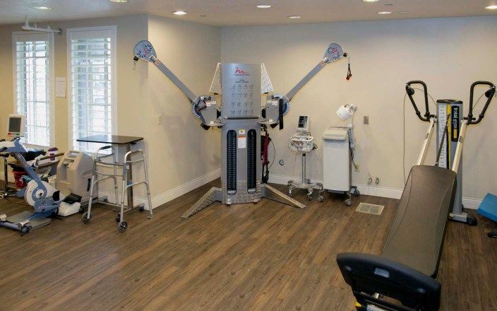 A therapy room equipped with advanced medical and rehabilitation machines.