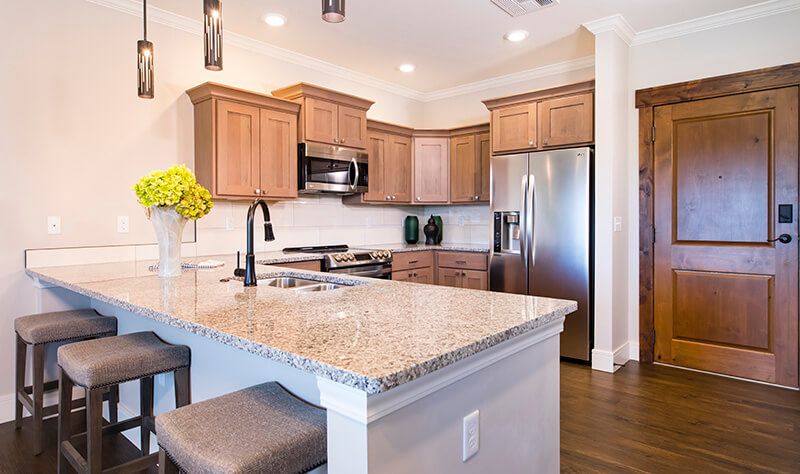 Modern kitchen with granite countertops and stainless steel appliances.