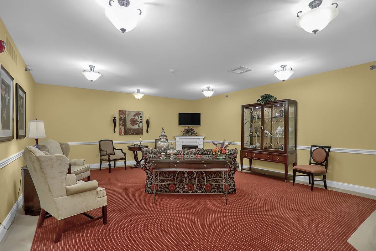 A traditionally styled living room with elegant furniture and warm lighting.