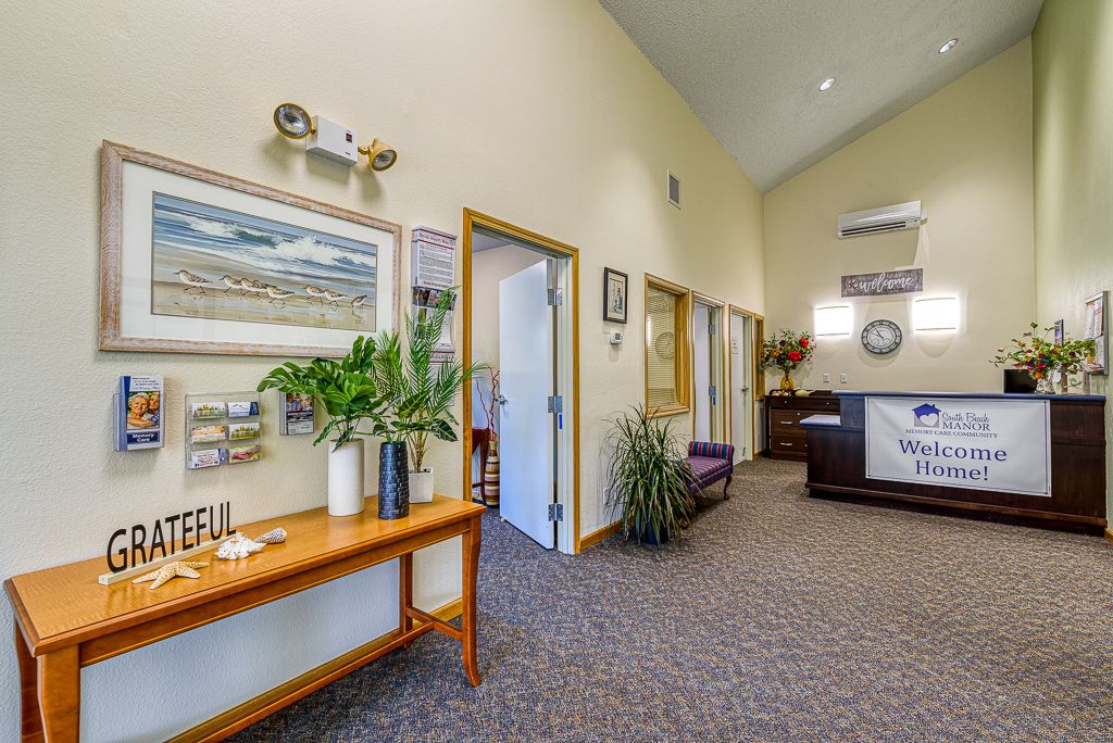A welcoming reception area with artwork and plants creating a cozy atmosphere.