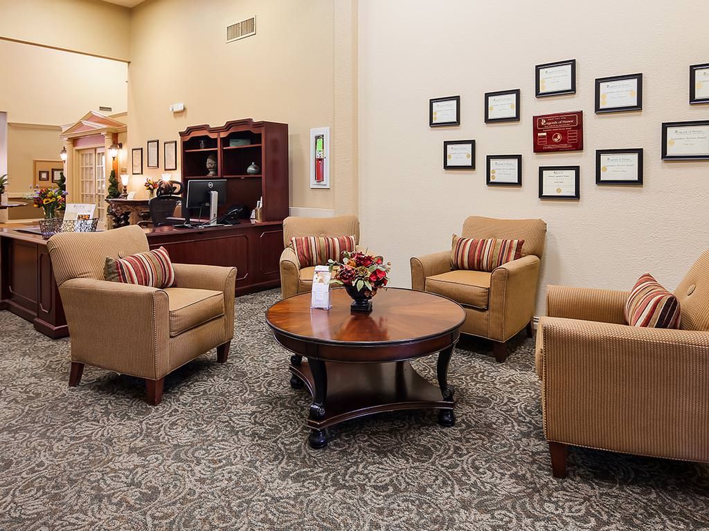 A cozy office waiting area with comfortable chairs and a central table.