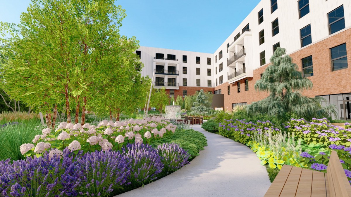 A beautiful garden with colorful flowers and a pathway, surrounded by a modern residential building.