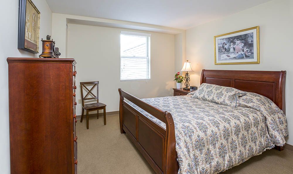 A cozy bedroom with classic wooden furniture and elegant decor.