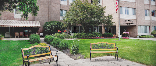 A tranquil outdoor space featuring well-maintained benches and lush greenery.
