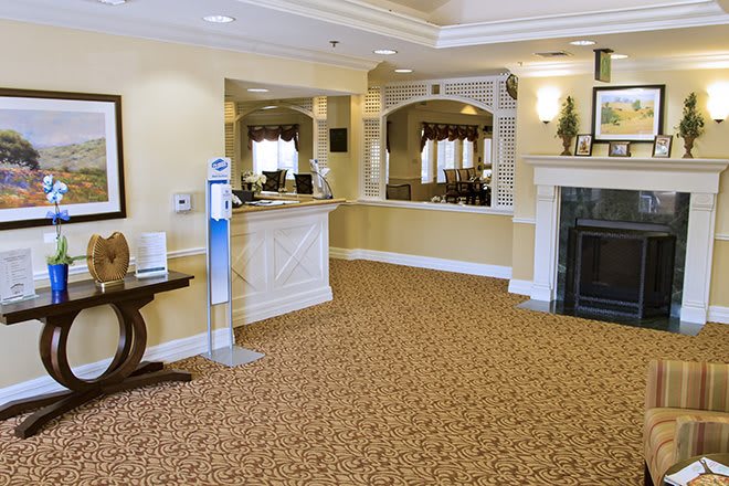 An inviting hotel lobby with a reception area and comfortable decor.