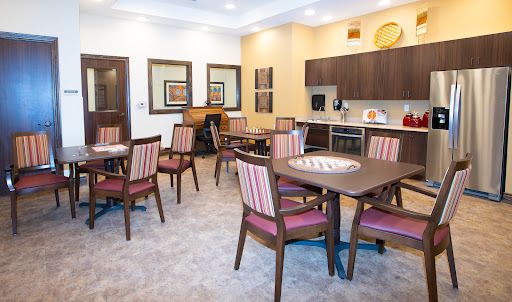 A modern dining area featuring stylish furniture and a well-equipped kitchen.