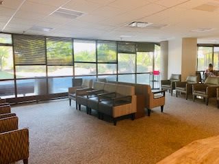 Spacious lobby area with seating and large windows.
