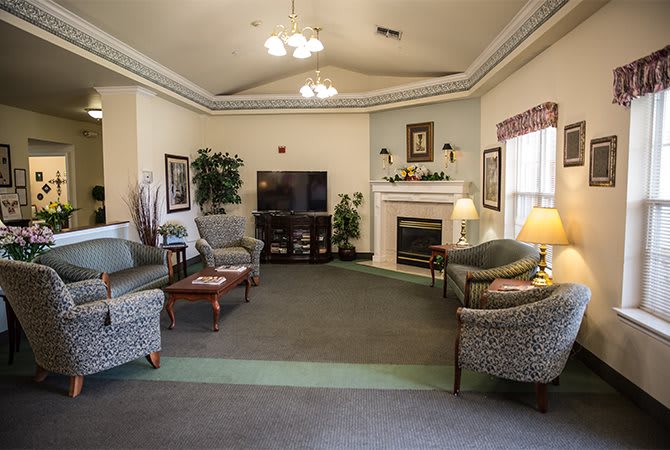 A cozy living room with a fireplace, TV, and comfortable seating.