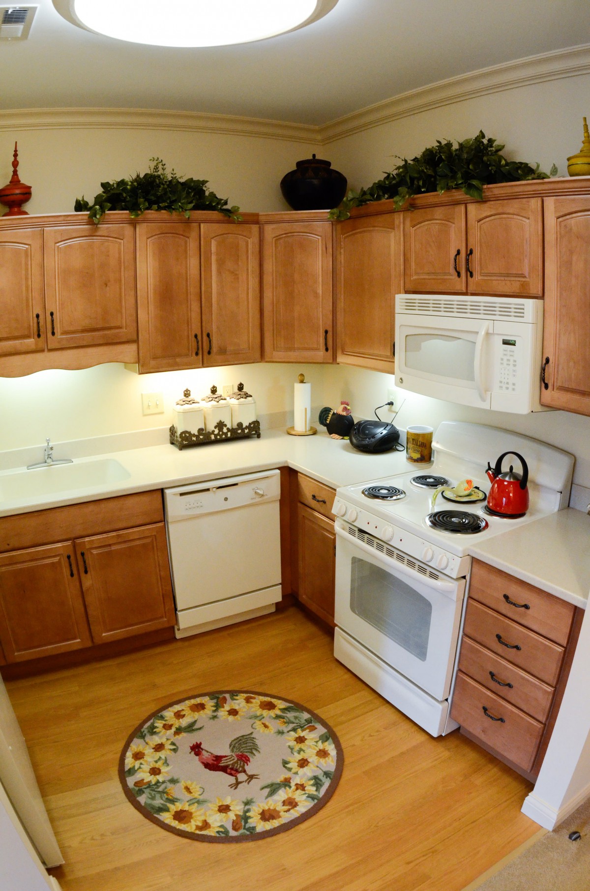 A cozy kitchen with wooden cabinets and a variety of appliances.
