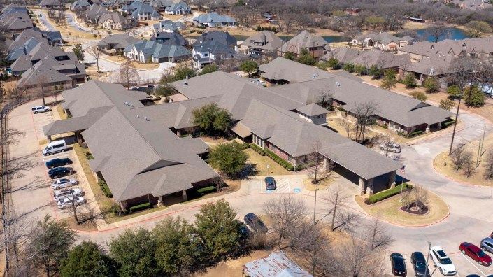 Aerial view of a suburban neighborhood with multiple houses and trees.