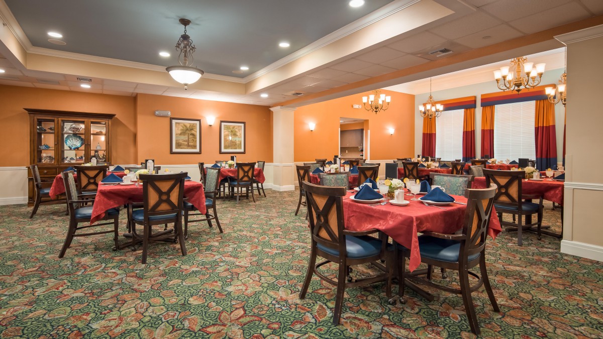 A well-decorated dining room with neatly arranged tables and chairs.