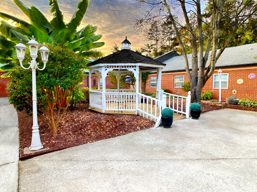 A charming gazebo nestled in a serene garden setting, perfect for relaxation and enjoying nature.