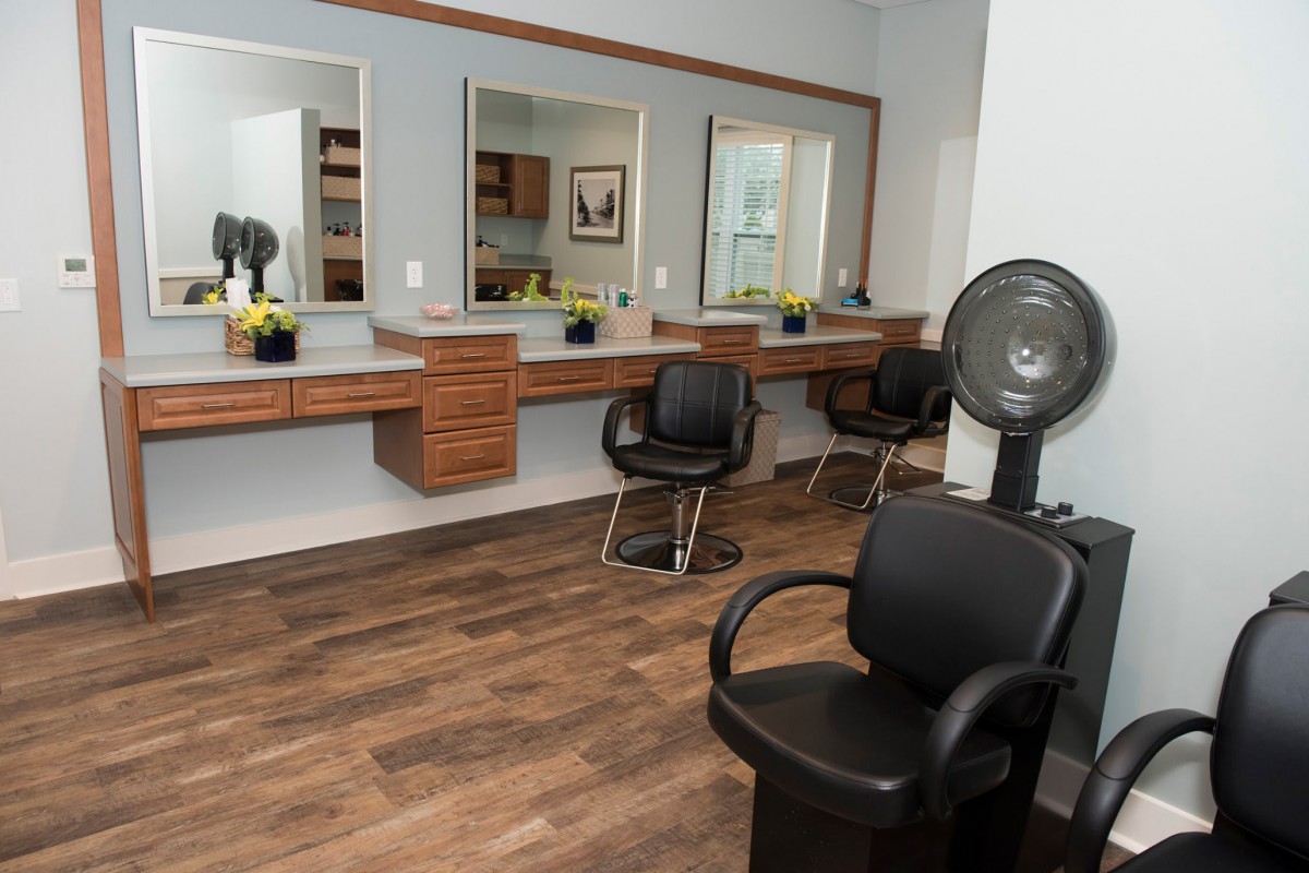 A modern hair salon with styling stations and comfortable chairs.