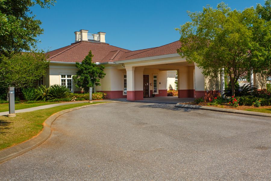 The entrance of a large medical facility with a circular driveway.