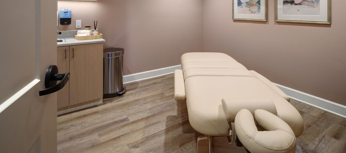 A serene therapy room with a massage table ready for a relaxing session.