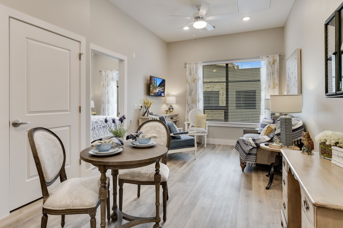 A cozy living and dining area with modern furniture and ample natural light.