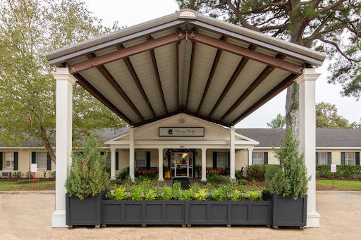 A welcoming entrance featuring a large canopy and well-maintained landscaping.