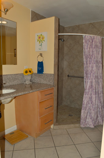 A well-designed bathroom featuring a shower, sink, and decorative elements.